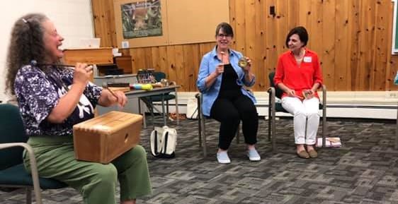 Corinne Rockow leading a music session at Higgins Lake Retreat