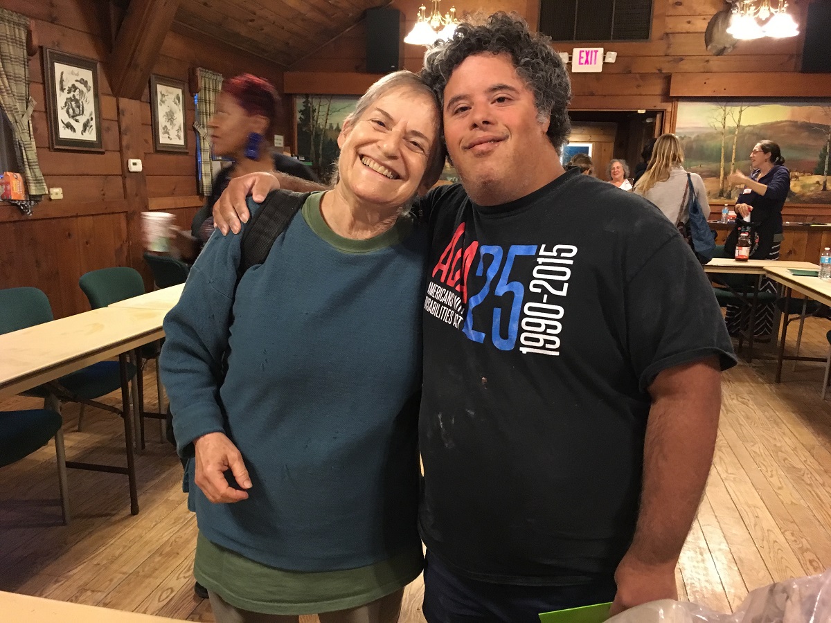 Susan Burack and Teddy Fitzmaurice arm in arm smiling at Higgins Lake retreat