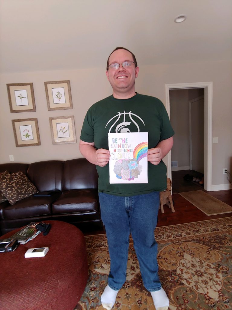 Michael White showing his artwork in his living room