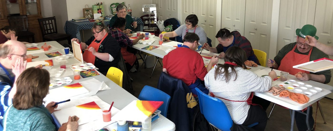 The whole Club Create Swartz Creek membership working on their artwork at two long tables