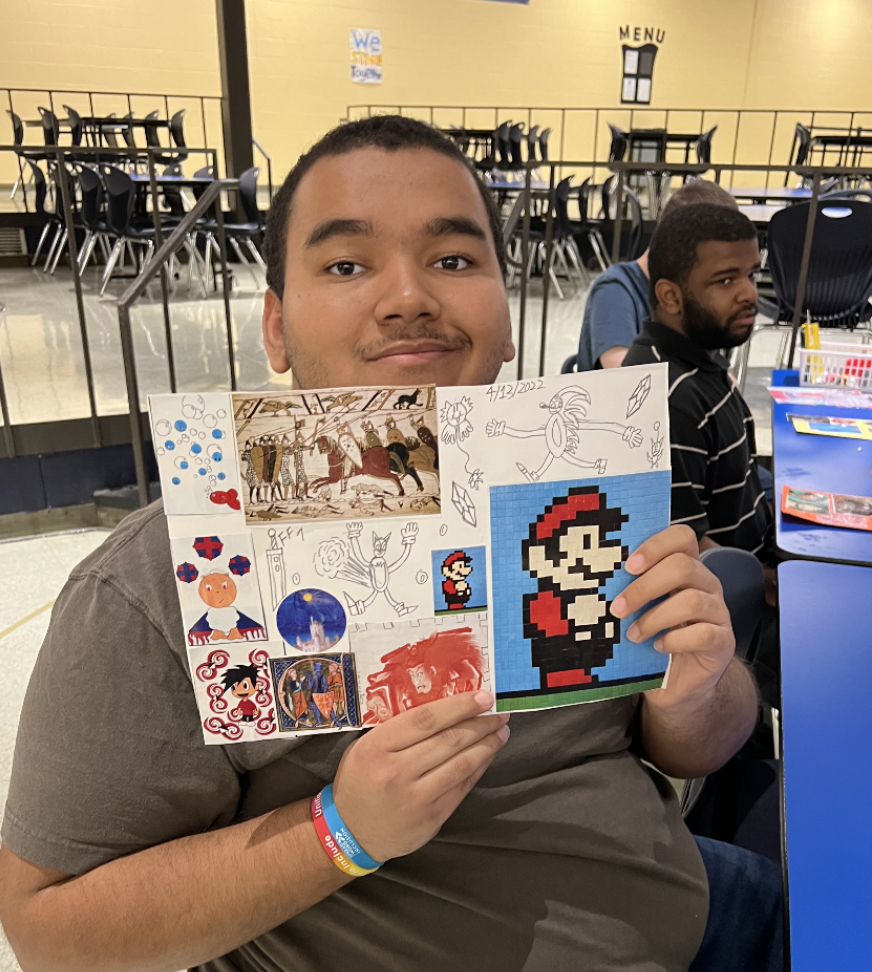 Student smiling and posing showing off their collage. 