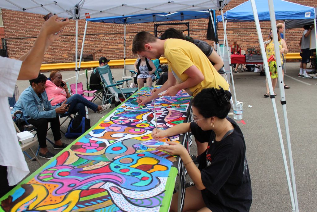 Participants painting mural.