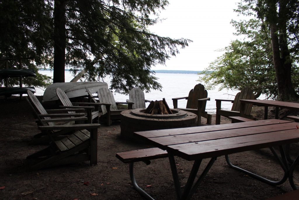 Chairs around the fire pit on Higgins Lake. 